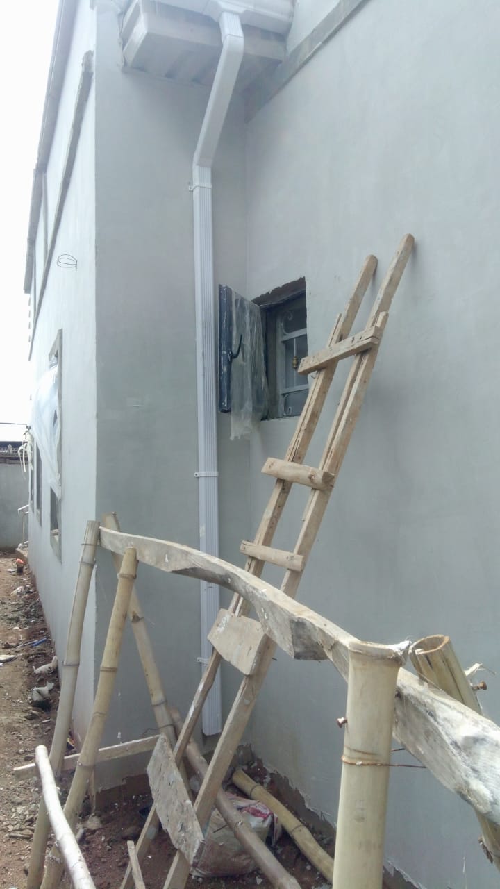 Rainwater gutter downspout installation and exterior wall painting