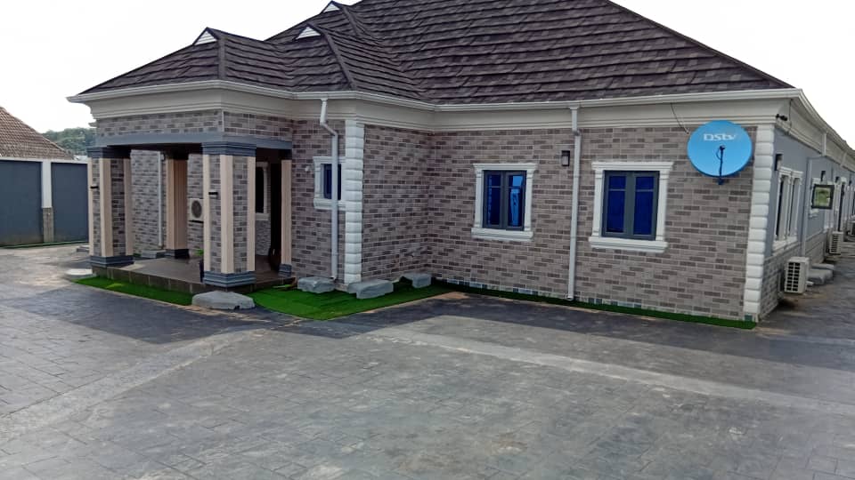 Close up exterior elevation showing stone tile cladding and stamped driveway