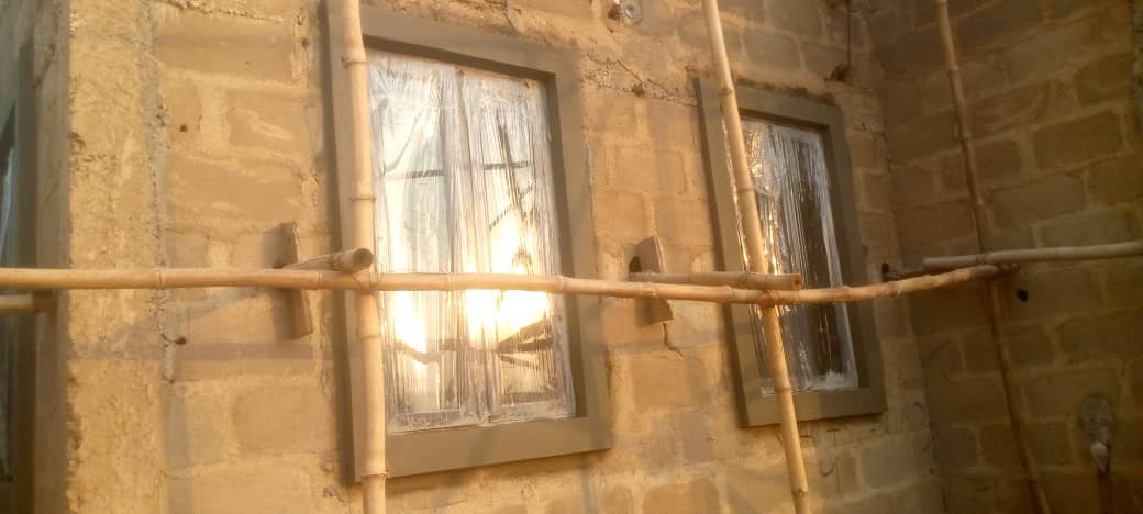 Concrete window frame moulding installation on active build